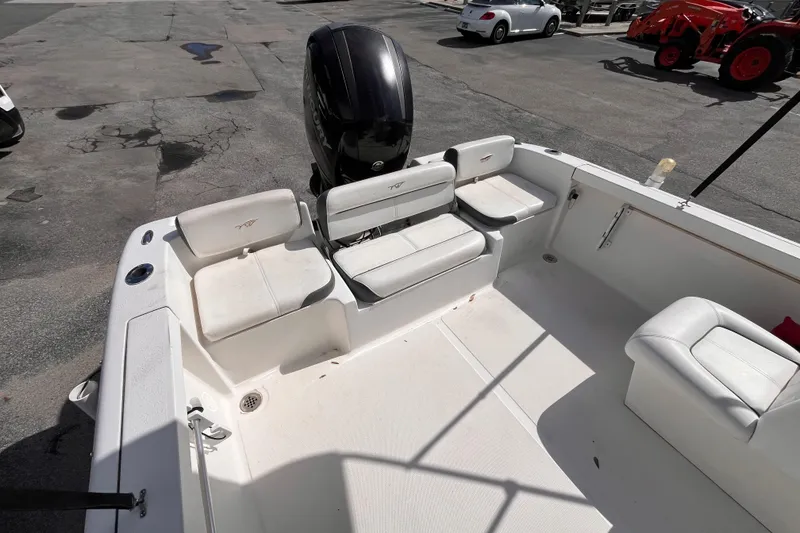 Slide: The Image of 2014 Tidewater 196 DC Explorer boat interior with seating and outboard motor. - 6