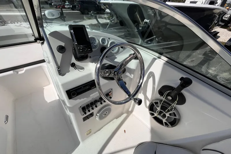 Slide: The Image of 2014 Tidewater 196 DC Explorer boat dashboard with steering wheel and controls. - 8