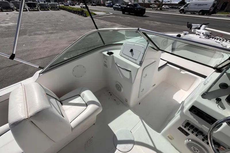 Slide: The Image of 2014 Tidewater 196 DC Explorer boat interior with seating and control panel. - 9
