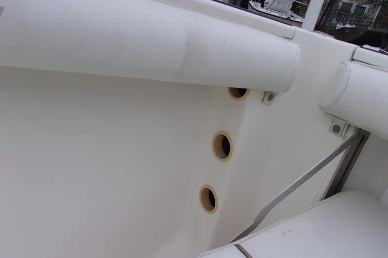 Slide: The Image of Interior view of a 1998 Wellcraft 210 Sportsman boat, featuring white cushioned seating. - 10