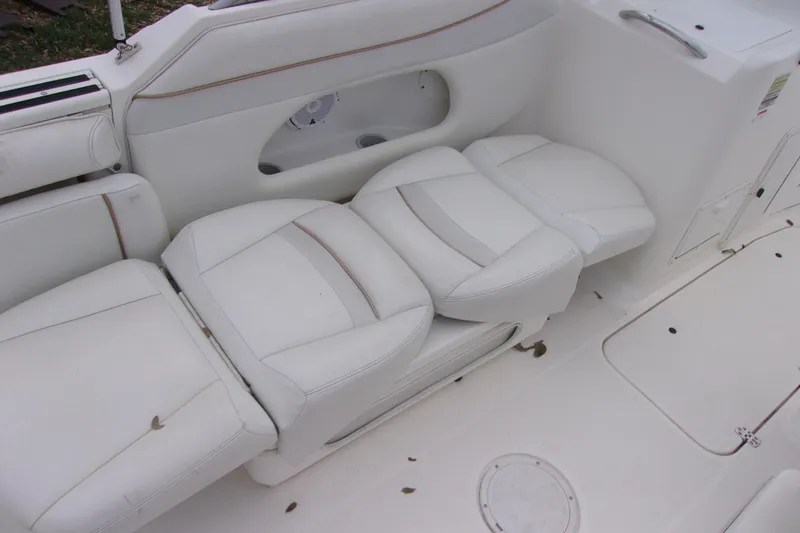 Slide: The Image of White seating on a 1998 Wellcraft 210 Sportsman boat, featuring clean upholstery. - 12