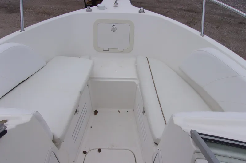 Slide: The Image of 1998 Wellcraft 210 Sportsman boat interior with white seating and storage compartments. - 13