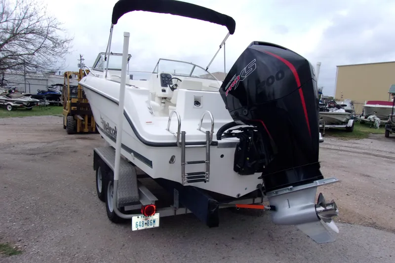 Slide: The Image of 1998 Wellcraft 210 Sportsman boat on trailer with powerful outboard motor. - 3