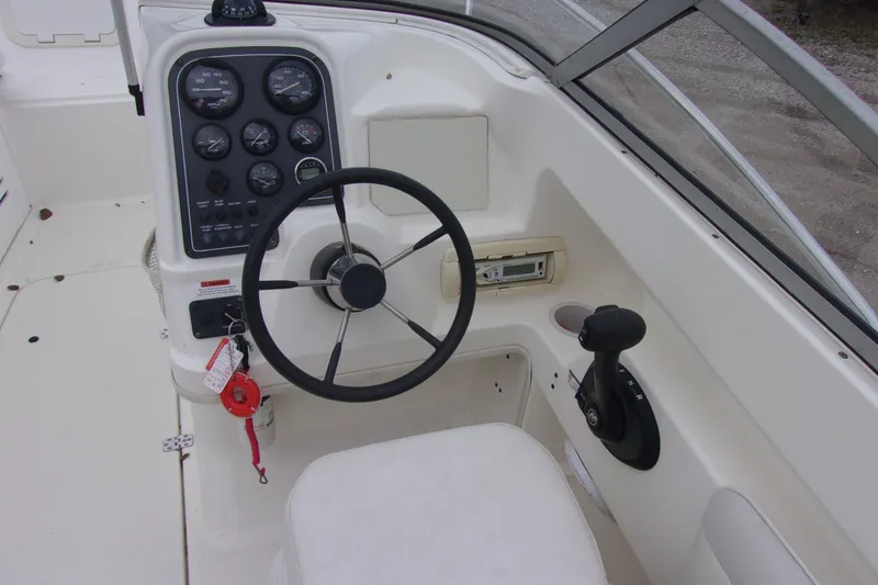 Slide: The Image of 1998 Wellcraft 210 Sportsman boat dashboard with steering wheel and control panel. - 5