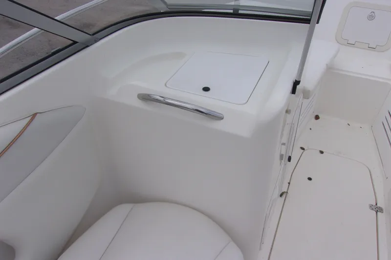 Slide: The Image of 1998 Wellcraft 210 Sportsman boat interior, featuring white seating and storage compartments. - 6