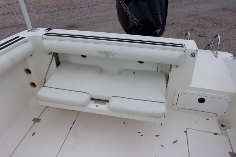 Slide: The Image of 1998 Wellcraft 210 Sportsman boat interior with white seating and storage compartments. - 8