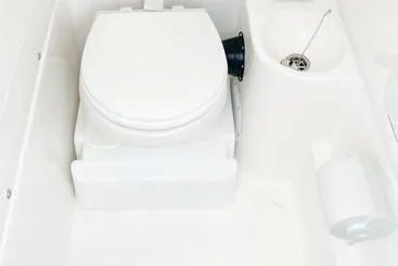 Slide: The Image of 2023 Fountain 34 Tournament Edition boat bathroom with toilet and sink. - 11
