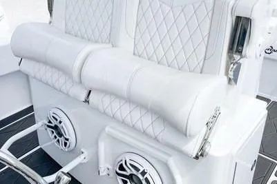 Slide: The Image of 2023 Fountain 34 Tournament Edition boat seating with diamond-stitched upholstery and integrated speakers. - 12