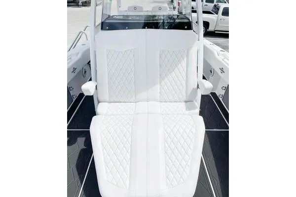 Slide: The Image of 2023 Fountain 34 Tournament Edition boat with luxurious white seating and diamond stitching. - 14