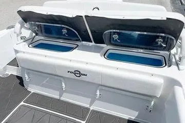Slide: The Image of 2023 Fountain 34 Tournament Edition boat with open storage compartments. - 3