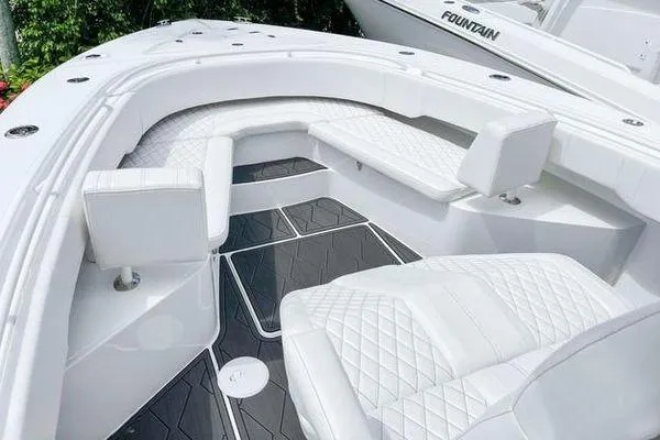 Slide: The Image of 2023 Fountain 34 Tournament Edition boat with luxurious white seating and sleek design. - 8
