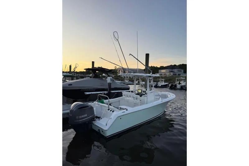 Slide: The Image of 2016 Sea Hunt Ultra 235 SE boat docked at sunset with Yamaha engine. - 7