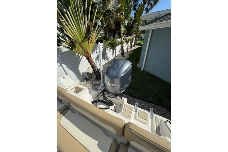 Slide: The Image of 2018 Key West 239 FS boat with Yamaha 250 engine, parked near palm trees. - 3