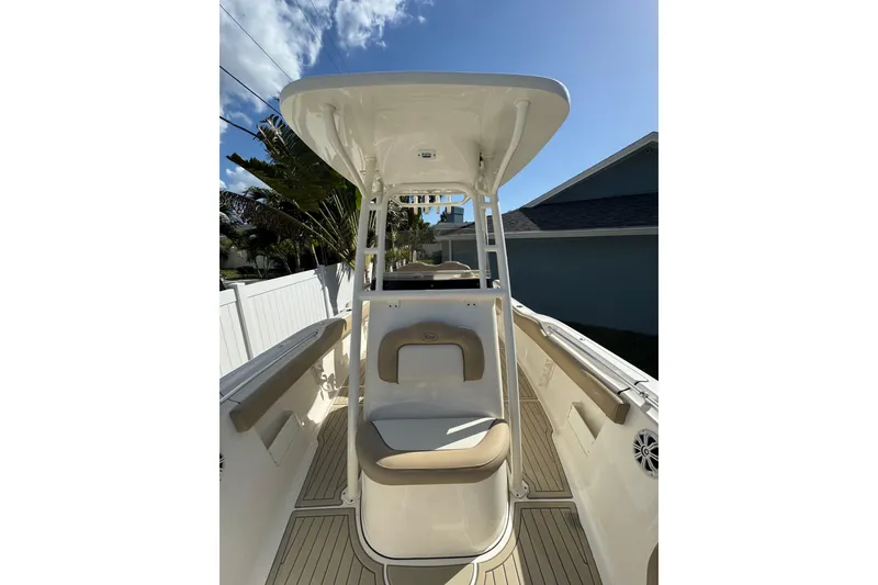 Slide: The Image of 2018 Key West 239 FS boat interior with seating and T-top under clear sky. - 9