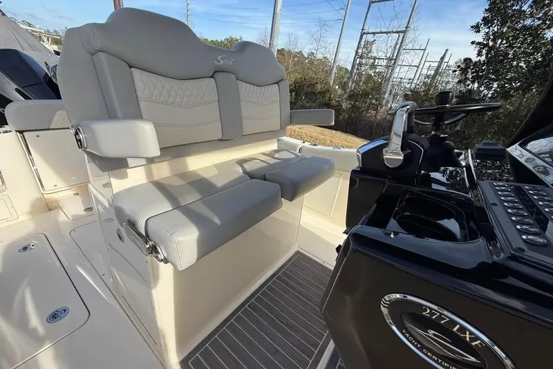 Slide: The Image of 2026 Scout 277 LXF boat interior with luxurious seating and modern helm controls. - 11