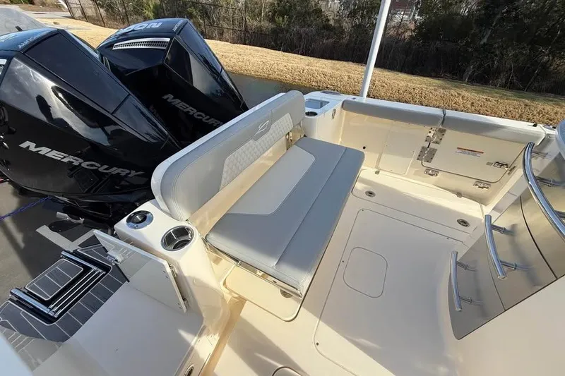 Slide: The Image of 2026 Scout 277 LXF boat interior with seating and dual Mercury engines. - 13
