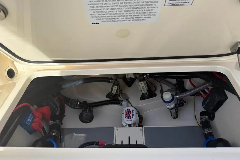 Slide: The Image of 2026 Scout 277 LXF boat compartment with wiring and components visible. - 14