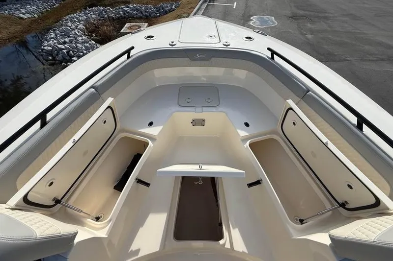 Slide: The Image of 2026 Scout 277 LXF boat interior with open storage compartments and seating. - 7