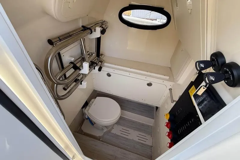 Slide: The Image of 2026 Scout 277 LXF boat interior with compact bathroom and modern fixtures. - 9
