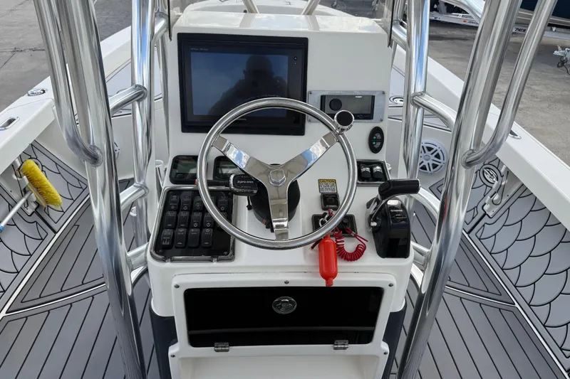 Slide: The Image of 2015 Pathfinder 2600 HPS boat console with steering wheel and navigation controls. - 10