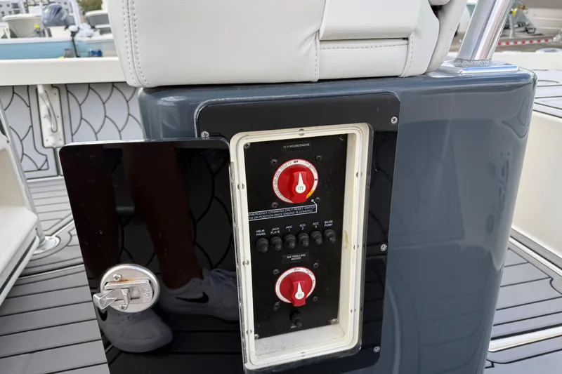 Slide: The Image of Control panel on a 2015 Pathfinder 2600 HPS boat, featuring switches and dials. - 12