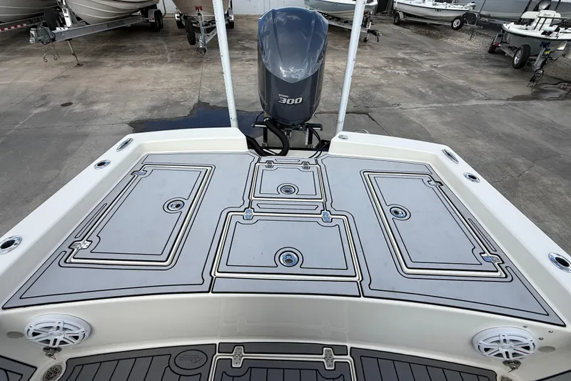 Slide: The Image of 2015 Pathfinder 2600 HPS boat deck with 300 HP engine, parked in a marina. - 14