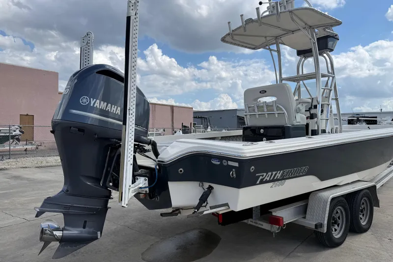 Slide: The Image of 2015 Pathfinder 2600 HPS boat with Yamaha engine on trailer, parked outdoors. - 3