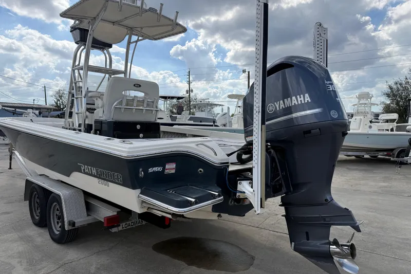 Slide: The Image of 2015 Pathfinder 2600 HPS boat with Yamaha engine on trailer, parked outdoors. - 5