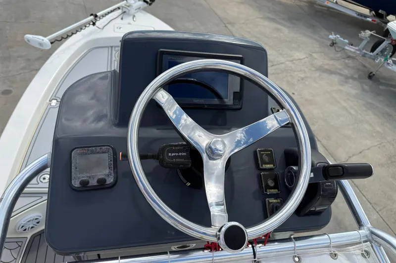 Slide: The Image of 2015 Pathfinder 2600 HPS boat console with steering wheel and controls. - 6