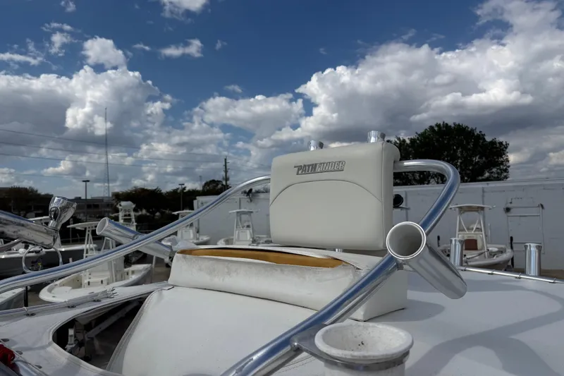 Slide: The Image of 2015 Pathfinder 2600 HPS boat with rod holders under a cloudy sky. - 7