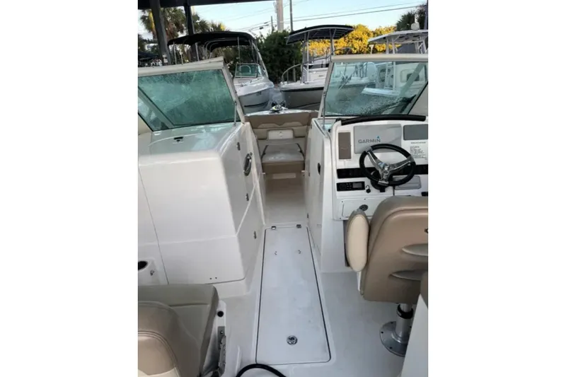 Slide: The Image of 2019 Sailfish 275 DC boat interior with steering wheel and seating. - 3