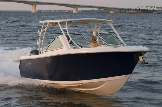 Slide: The Image of Manufacturer Provided Image: 2019 Sailfish 275 DC boat cruising on water near a bridge. - 7