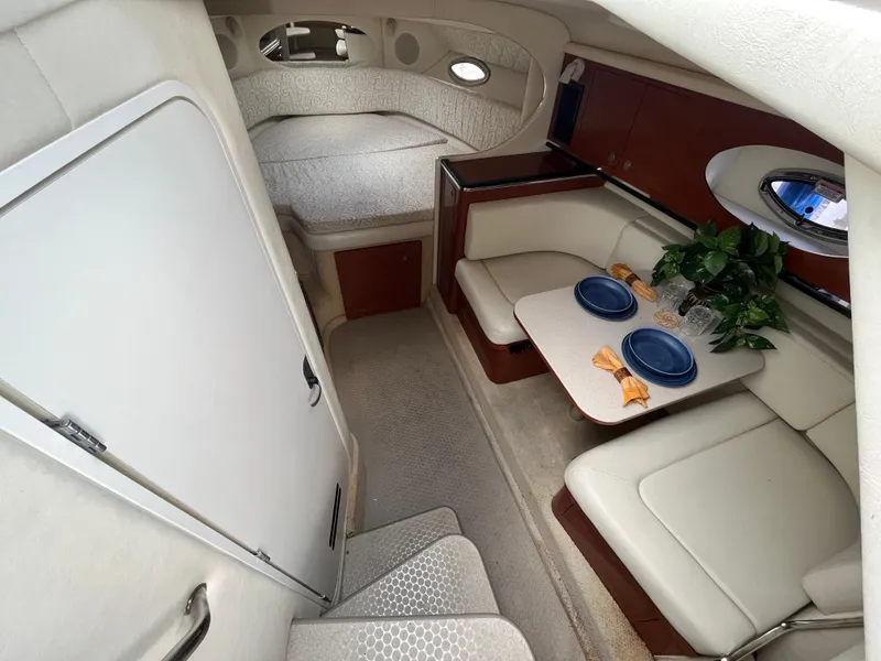 Slide: The Image of 2005 Sea Ray 290 Amberjack cabin interior with dining area and sleeping quarters. - 10