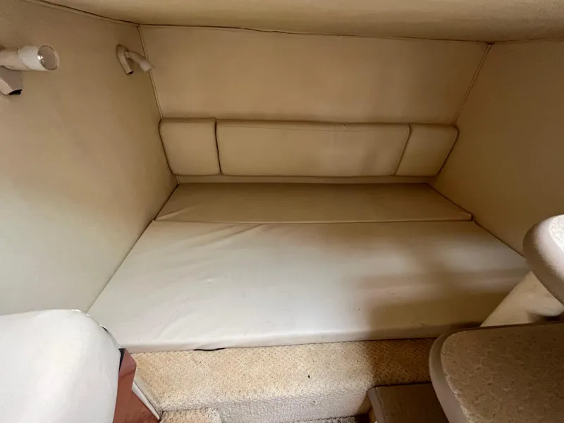Slide: The Image of Interior cabin of a 2005 Sea Ray 290 Amberjack boat with beige upholstery. - 15