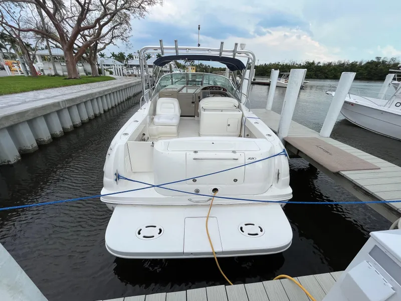 Slide: The Image of 2005 Sea Ray 290 Amberjack docked at marina, rear view. - 2
