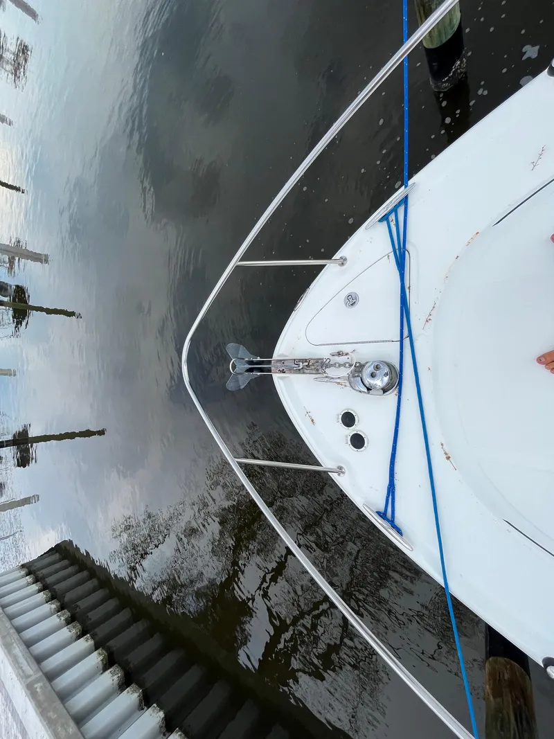 Slide: The Image of 2005 Sea Ray 290 Amberjack boat docked, top view of bow with anchor and blue ropes. - 5