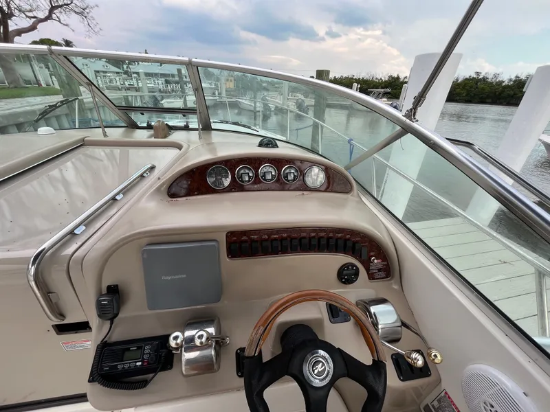 Slide: The Image of 2005 Sea Ray 290 Amberjack boat helm with steering wheel and control panel. - 8