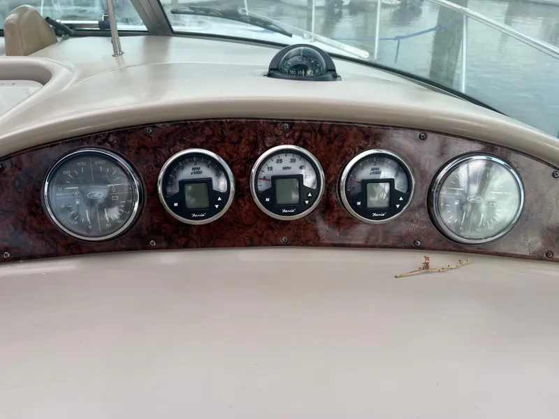 Slide: The Image of Dashboard of a 2005 Sea Ray 290 Amberjack boat with gauges and compass. - 9