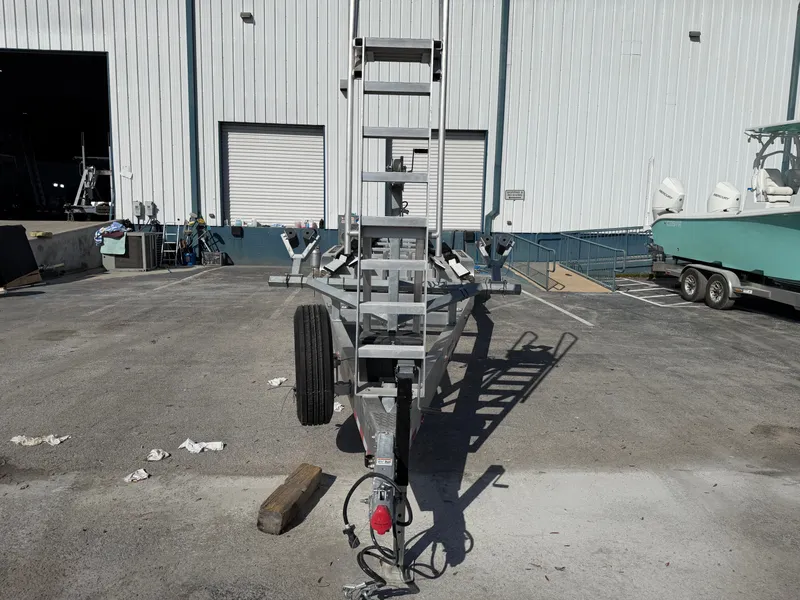 Slide: The Image of Boat trailer in front of warehouse, Costa Custom Boats 34, 2025. - 2