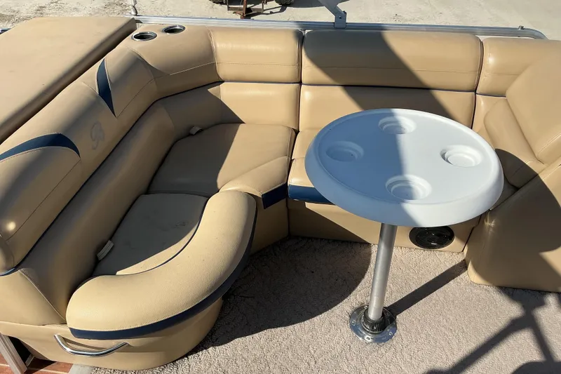 Slide: The Image of 2018 Berkshire 23RFC STS Fish boat interior with tan seating and round table. - 11
