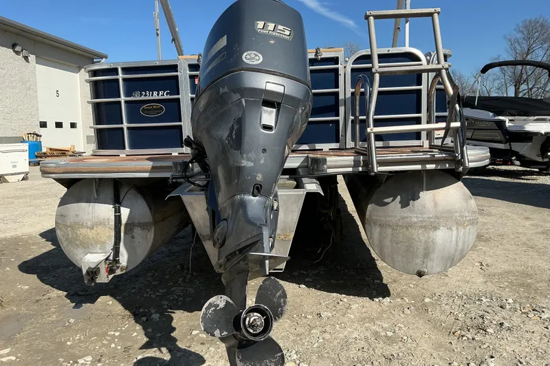 Slide: The Image of 2018 Berkshire 23RFC STS Fish pontoon boat with outboard motor, parked outdoors. - 5