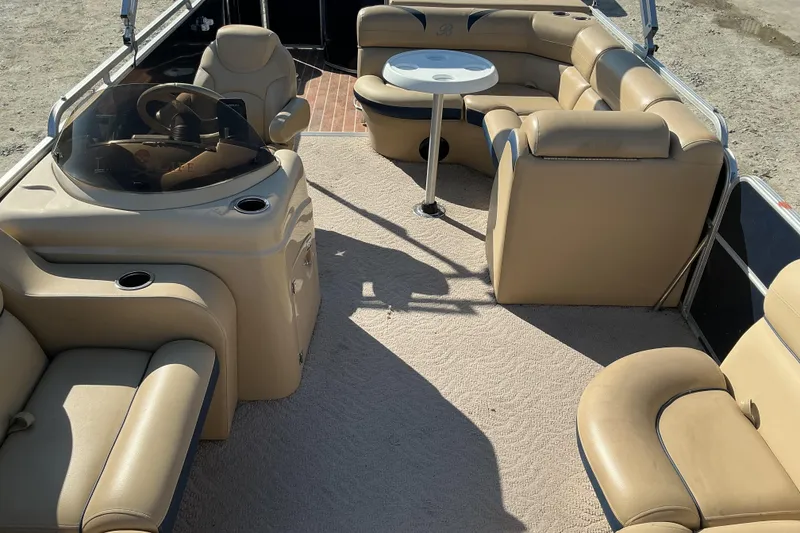 Slide: The Image of 2018 Berkshire 23RFC STS Fish pontoon boat interior with beige seating and steering console. - 6