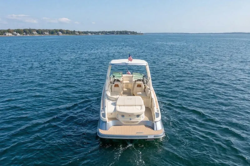 Slide: The Image of 2023 Chris-Craft Launch 28 GT boat on open water, rear view. - 3