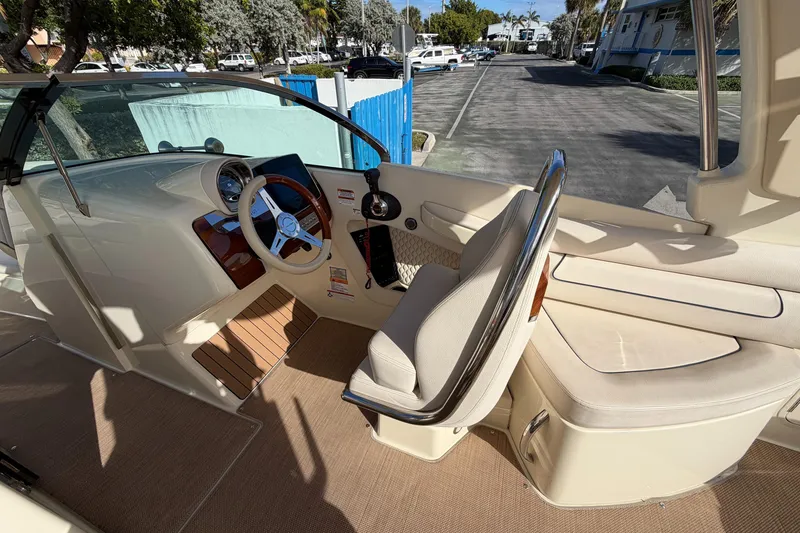 Slide: The Image of 2023 Chris-Craft Launch 28 GT interior with steering wheel and seating area. - 8