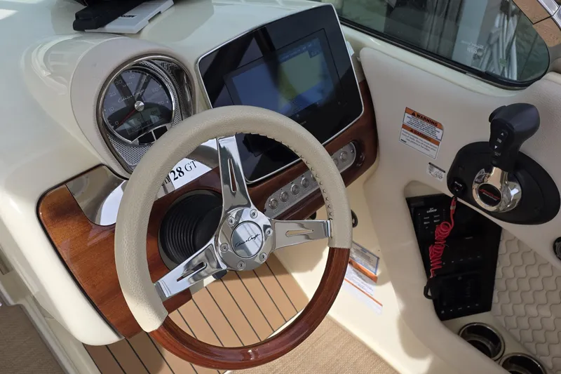 Slide: The Image of 2023 Chris-Craft Launch 28 GT dashboard with steering wheel and control panel. - 9