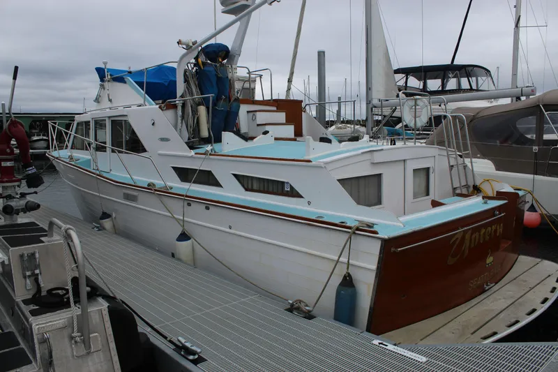 The Image of 1969 Pacemaker Tricabin boat docked at marina, featuring classic design and wooden accents. - 1