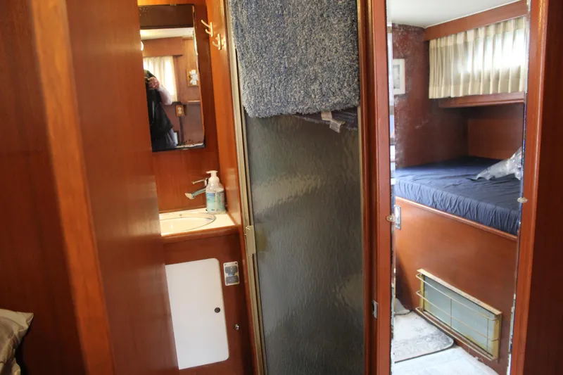 Slide: The Image of 1969 Pacemaker Tricabin interior with wooden finish, bathroom, and cozy sleeping area. - 10