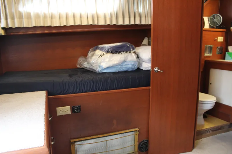 Slide: The Image of 1969 Pacemaker Tricabin interior with bed, wooden paneling, and bathroom view. - 12