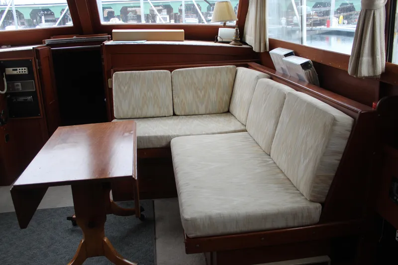 Slide: The Image of 1969 Pacemaker Tricabin interior with cushioned seating and wooden table. - 14