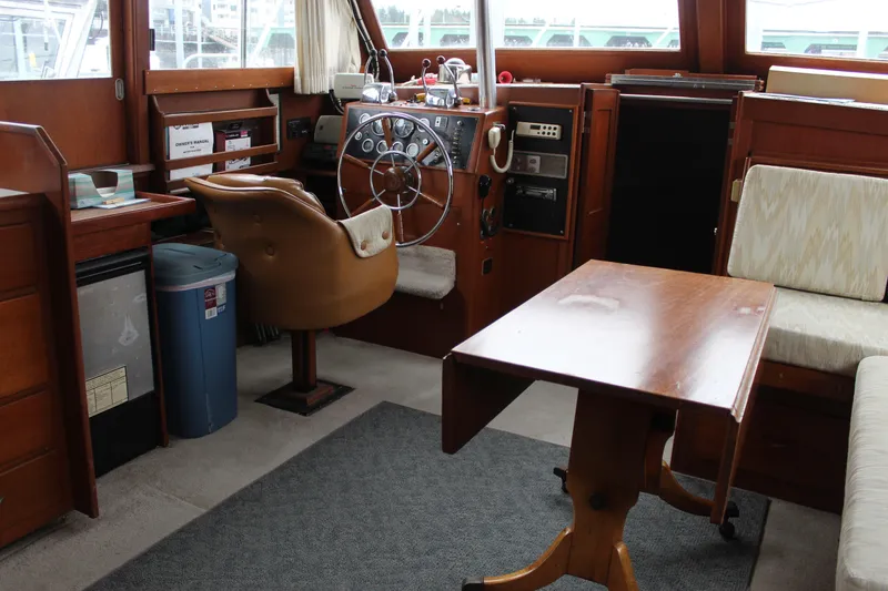 Slide: The Image of 1969 Pacemaker Tricabin boat interior with steering wheel, seating, and wooden table. - 15